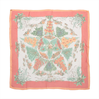 Hermès Carré 90 "Pythagore" silk handkerchief in orange featuring a symmetrical botanical design with flowers, leaves, and fruits in pastel green, orange, and red tones on a white background with a coral-orange border.