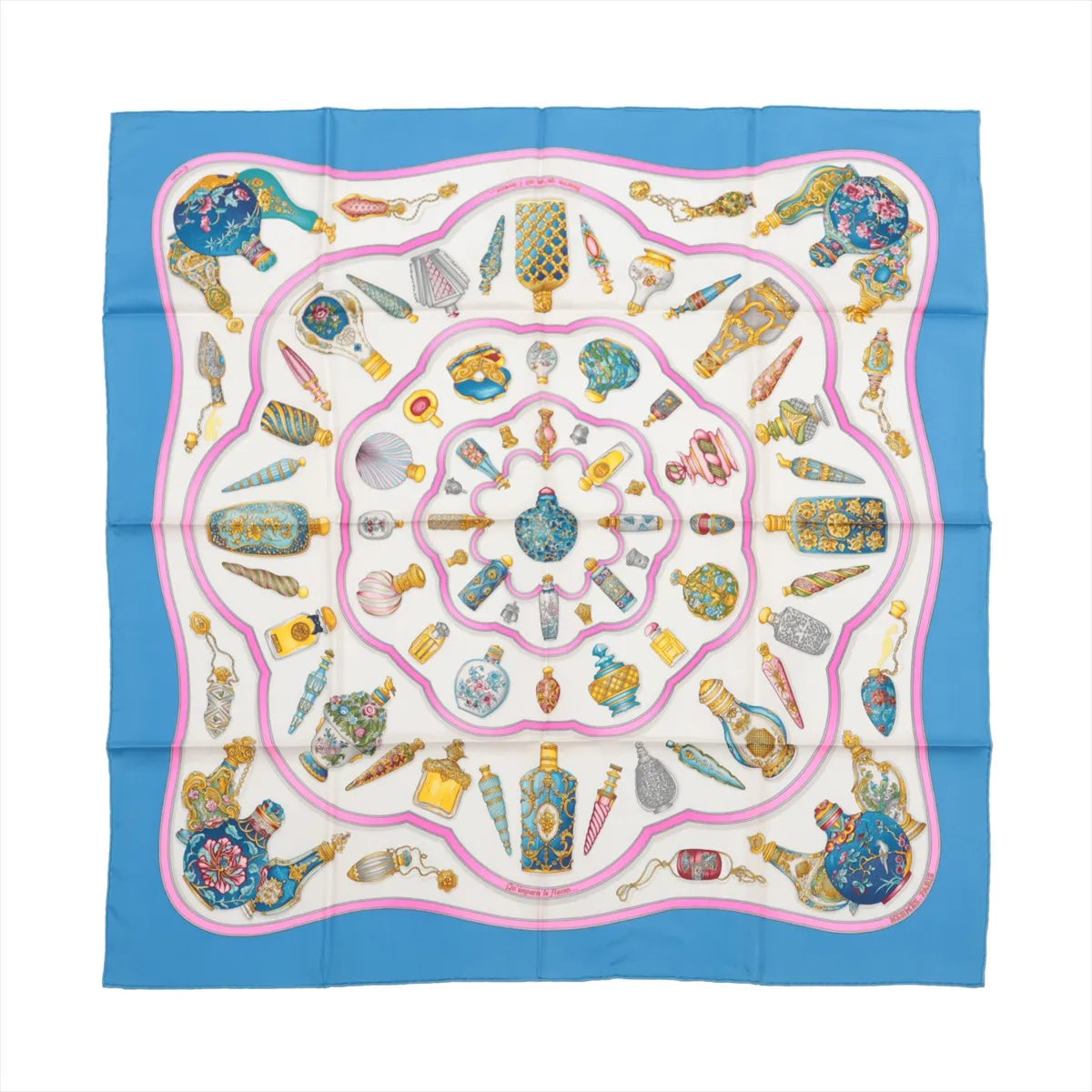 Hermès Carré 90 "Qu'importe Le Flacon" silk scarf in blue, featuring a circular arrangement of intricately illustrated vintage perfume bottles in gold, pink, turquoise, and white on a cream background with a pink-lined border and blue outer edge.