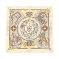 Hermès Carré 90 beige silk scarf with intricate illustrated Australian motifs in earthy tones, yellow accents, and a central circular medallion design.