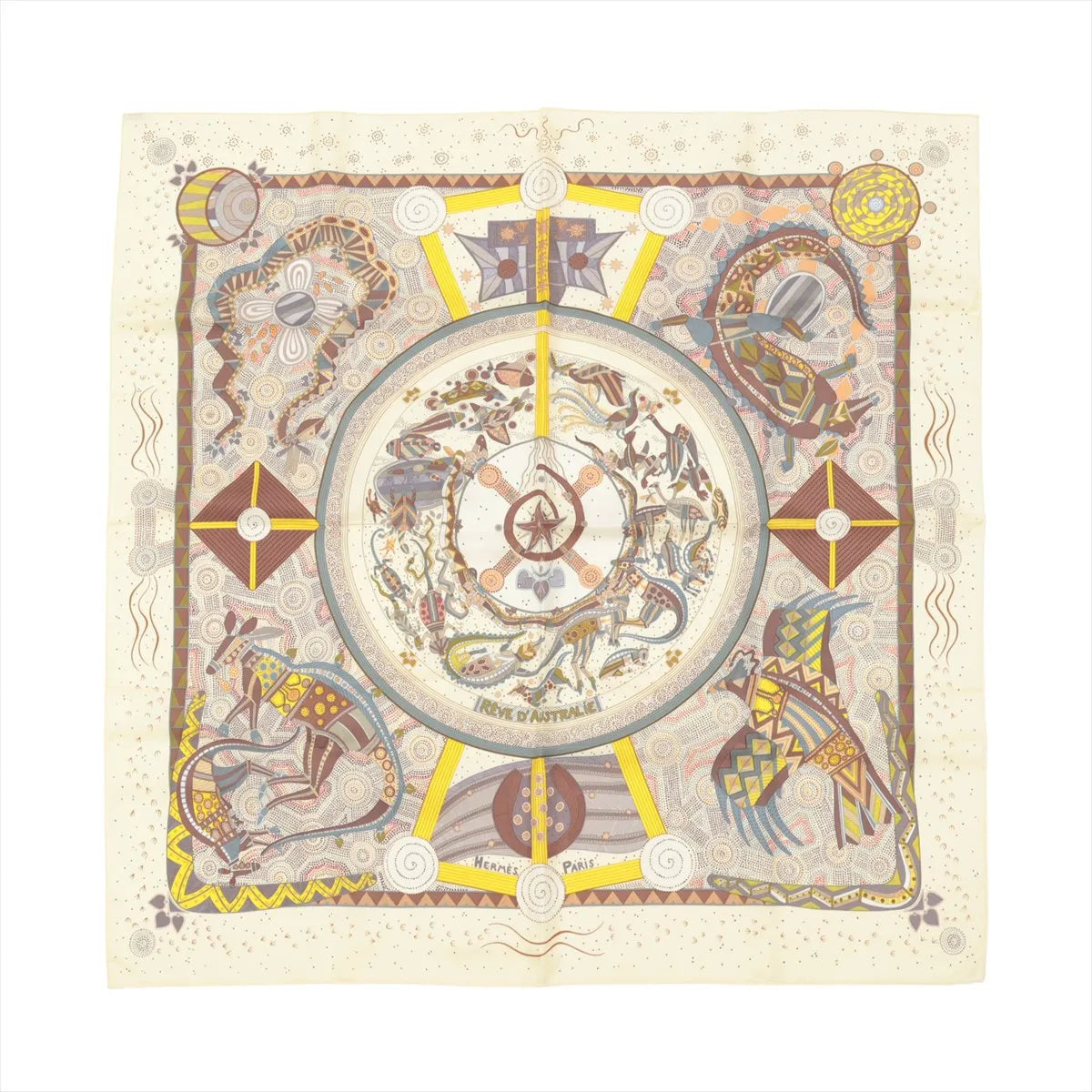Hermès Carré 90 beige silk scarf with intricate illustrated Australian motifs in earthy tones, yellow accents, and a central circular medallion design.