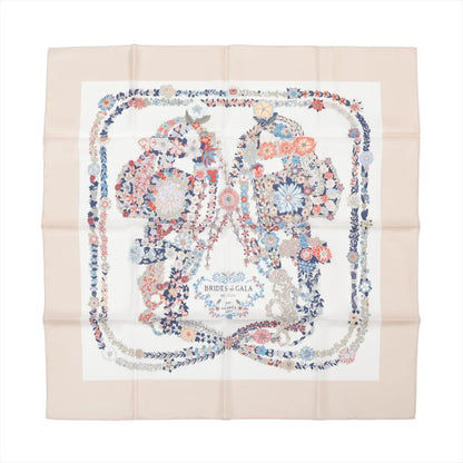 Hermès Carré 90 "Brides de Gala en Fleurs" silk scarf in beige featuring a detailed floral interpretation of bridles in blue, red, and white tones with a soft border.