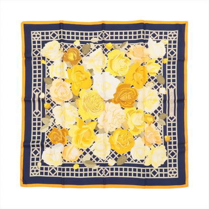 Hermès Carré 90 "ROSERAIE" silk scarf in yellow featuring an intricate lattice design filled with blooming yellow, cream, and orange roses, bordered in navy and orange.