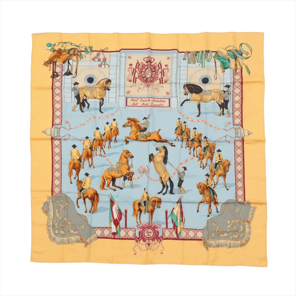 Hermès Carré 90 silk scarf in yellow with light blue center featuring horse-and-rider equestrian scenes and ornate border details.