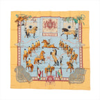 Hermès Carré 90 silk scarf in yellow with light blue center featuring horse-and-rider equestrian scenes and ornate border details.