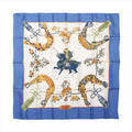 Hermès Carré 90 "SAMOURAI" silk scarf in blue with intricate samurai warrior and horse illustration at center, surrounded by golden stirrups, floral motifs, and tassels on an ivory background with a vivid blue border.