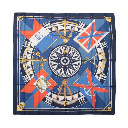 Hermès Carré 90 "SEXTANTS" silk scarf in blue featuring a central compass design surrounded by gold sextants, nautical flags, and directional markings, all bordered with a navy and gold frame.