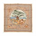Flat-lay image of Hermès Carré 90 "Sous le Cèdre" silk scarf featuring a central pastoral scene with a large cedar tree, oxen, and shepherds, surrounded by a beige and multicolor mosaic-style border.