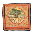 Hermès Carré 90 “Sous Le Cèdre” silk scarf in brown with orange mosaic-style border and central pastoral scene with a large cedar tree, laid flat on white background.