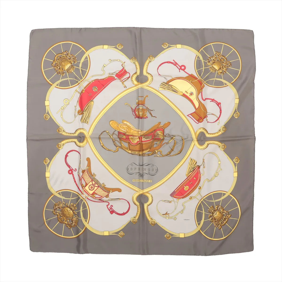 Hermès Carré 90 silk scarf titled "Springs," featuring detailed illustrations of golden and red horse-drawn carriages and harnesses arranged symmetrically on a light gray and taupe background, bordered with intricate gold wheel motifs.