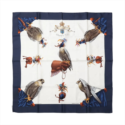 Hermès Carré 90 "Chasse à Vol" silk scarf in navy blue, showcasing falcons in falconry gear with gloves and feathered hoods on a white background.