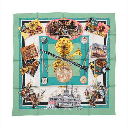 Hermès Carré 90 "The Original New Orleans Creole Jazz 1923" silk scarf in green featuring illustrated jazz musicians, brass instruments, a steamboat, a streetcar, and musical notes in a vibrant New Orleans theme.