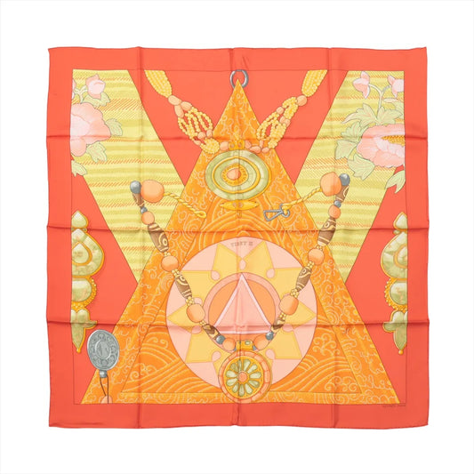 Hermès Carré 90 "Tibet" silk scarf in vibrant orange featuring geometric and spiritual symbols, including mandalas, beads, and floral accents, inspired by Tibetan culture and tradition.