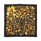 Hermès Carré 90 “Tourbillon” silk scarf in black with golden yellow and brown leaf motif arranged in a spiral pattern.