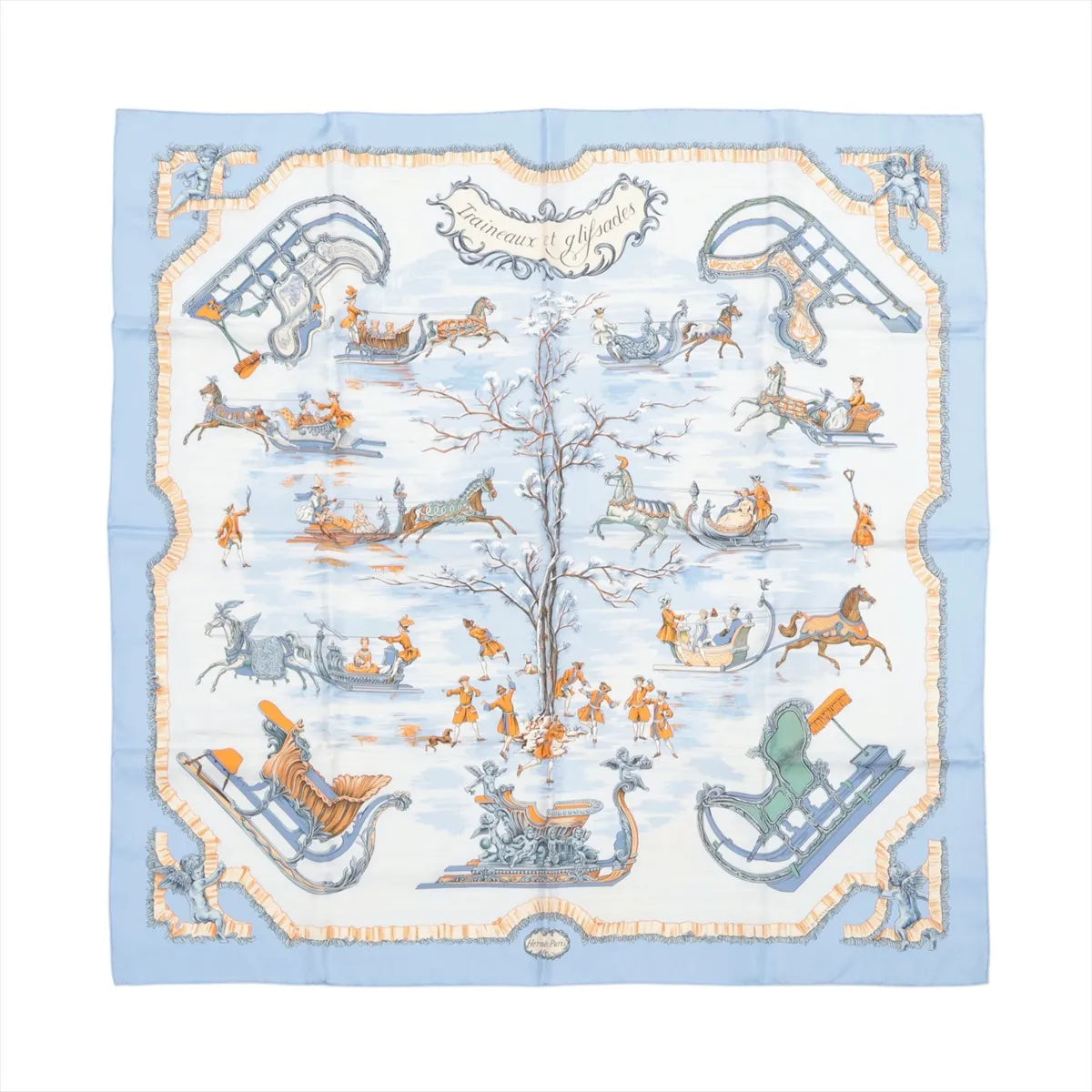 Hermès Carré 90 "Traineaux et Glissades" silk scarf in blue, featuring a central tree surrounded by horse-drawn sleighs, ice skaters, and winter motifs in soft orange, white, and grey tones with a blue and cream border.