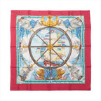 Hermès Carré 90 "VIVE LE VENT" silk scarf in red featuring central ship’s wheel design, detailed sailing ships, ocean waves, and maritime flags, bordered in vibrant red.