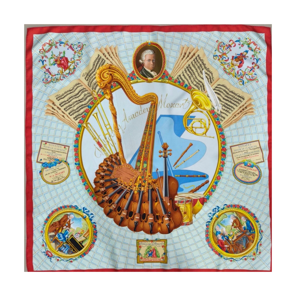 Hermès Carré 90 red and pale blue silk scarf with violins, harp, brass instruments, sheet music and portrait medallions.