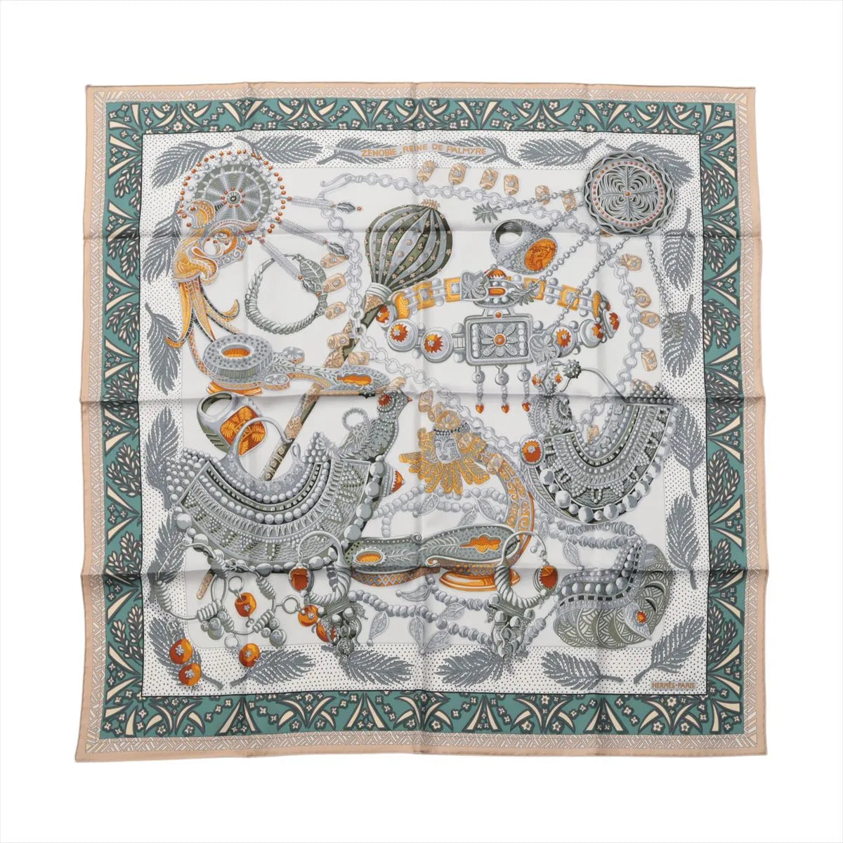 Hermès Carré 90 "Zenobie Reine de Palmyre" silk scarf in beige and green featuring intricately illustrated ancient jewelry in silver, gold, and orange tones, framed by a patterned green and beige border with palm fronds and decorative motifs.