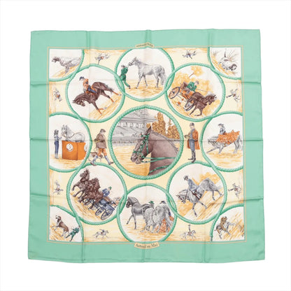 Hermès Carré 90 silk scarf in green with illustrated scenes of horse racing, carriage riding, and trainers, framed in circular vignettes on a cream background.