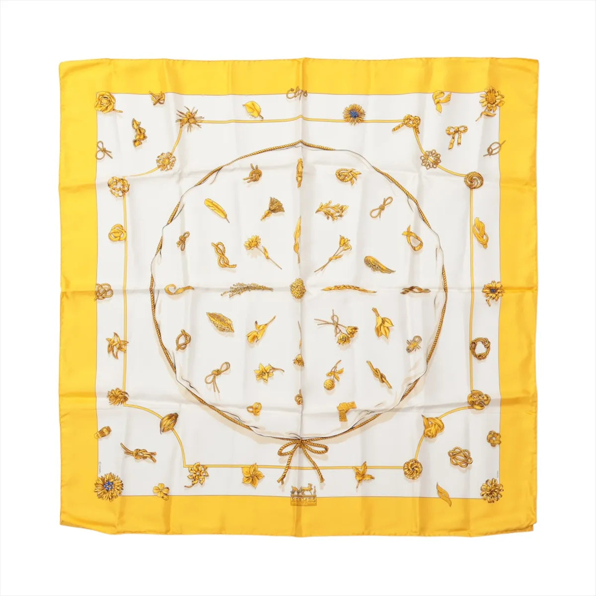 Hermès Carré 90 "Clips" silk handkerchief in yellow featuring gold-tone jewelry and brooch motifs on a white background with a vibrant yellow border.