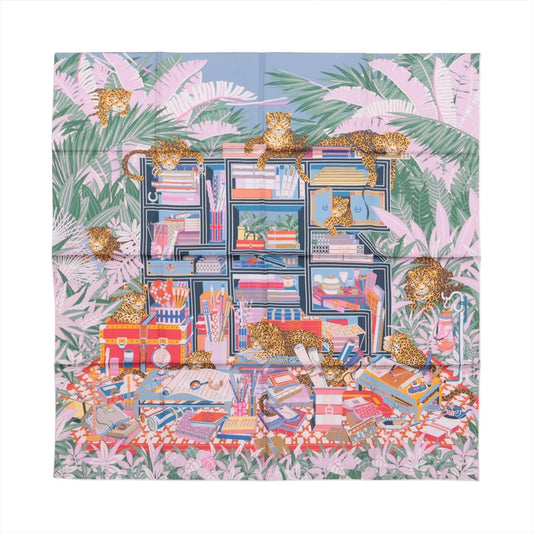 Hermès Carré 90 Double Face “Les Douze Léopards” silk scarf in multicolor, showcasing twelve leopards lounging among vibrant books, trunks, and foliage with a playful jungle theme.
