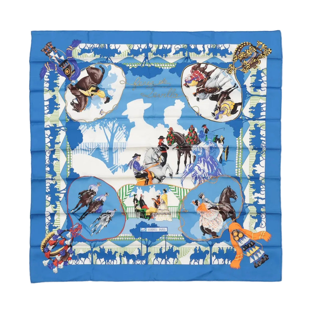 Blue Hermès Carré 90 square scarf with “Feria de Sevilla” illustration of horses, riders and dancers, framed by a bold blue border and Hermès Paris label.