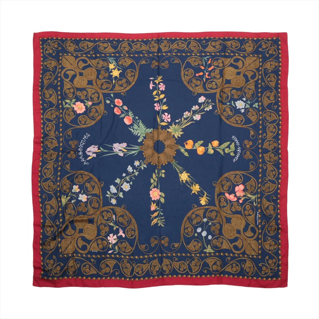 Hermès Carré Géant navy blue and red cashmere-silk scarf with ornate gold arabesque borders and multicolour floral motifs.