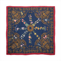 Hermès Carré Géant navy blue and red cashmere-silk scarf with ornate gold arabesque borders and multicolour floral motifs.