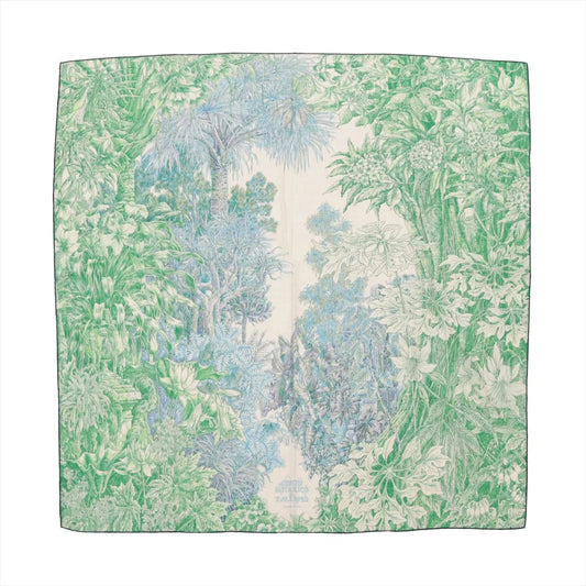Hermès Carré Geant "Botanico di Palermo" scarf in green, featuring an intricate botanical illustration with leaves, flowers, and trees on a soft cashmere and silk blend fabric, laid flat against a white background.