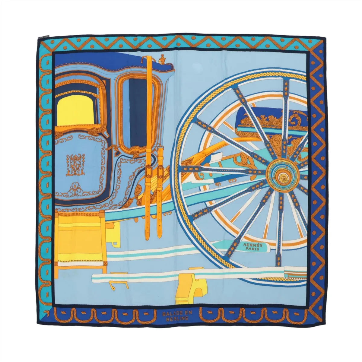 Hermès Carré 90 "Balade en Berline" cashmere and silk scarf in blue with an ornate carriage and large wheel in gold, turquoise, and navy tones.