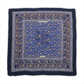 Hermès Carré Géant “Chasse en Inde” scarf in navy blue with detailed multicolor hunting scene motifs, made from a soft cashmere and silk blend.