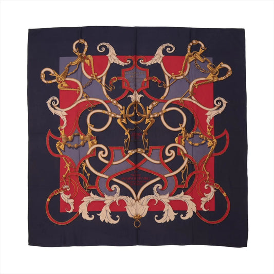 Hermès Carré Géant “L'Instruction du Roy” scarf in navy blue and red, featuring intricate gold equestrian and baroque-inspired designs on cashmere and silk fabric.