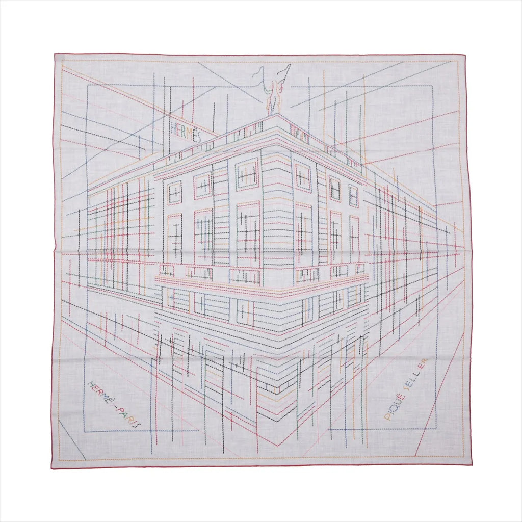 Hermès Carré Géant “Pique Sellier” gray cashmere-silk scarf with multicolor line drawing of a building, red border, and “Hermès Paris” text