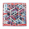 Hermès Carré Géant scarf in blue, red, and white with abstract zigzag strap and buckle pattern, geometric ribbon-like bands, and red border.