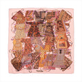 Hermès Carré 140 cashmere-silk scarf in pink with colorful textile collage pattern and “Voyage en Étoffes” title, laid flat on white background.