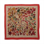 Hermès Carré Géant scarf with beige center, multicolor autumn leaf print in red, gold, green and brown, and a wide red border.