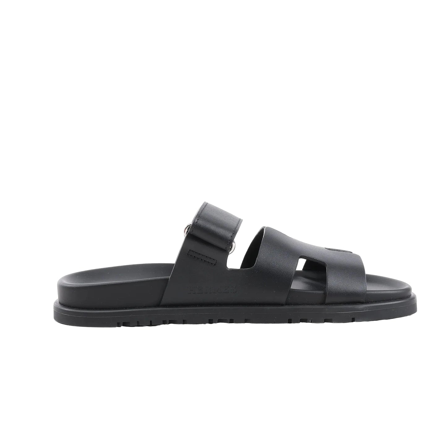 HERMÈS Cypre Leather Sandals in Black, Size 38.5 EU, featuring a smooth black leather upper with adjustable strap, signature “H” cut-out design, contoured footbed, and textured rubber sole, shown in a side profile against a white background.