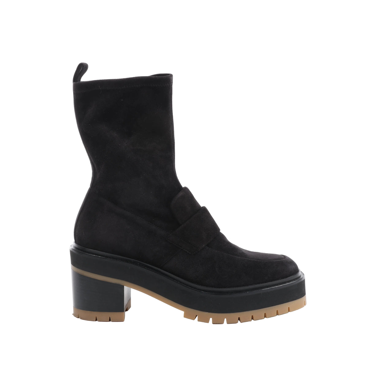 Side view of a black Hermès Florence suede boot with loafer-style detailing, a rear pull tab, block heel and chunky sole with tan tread.