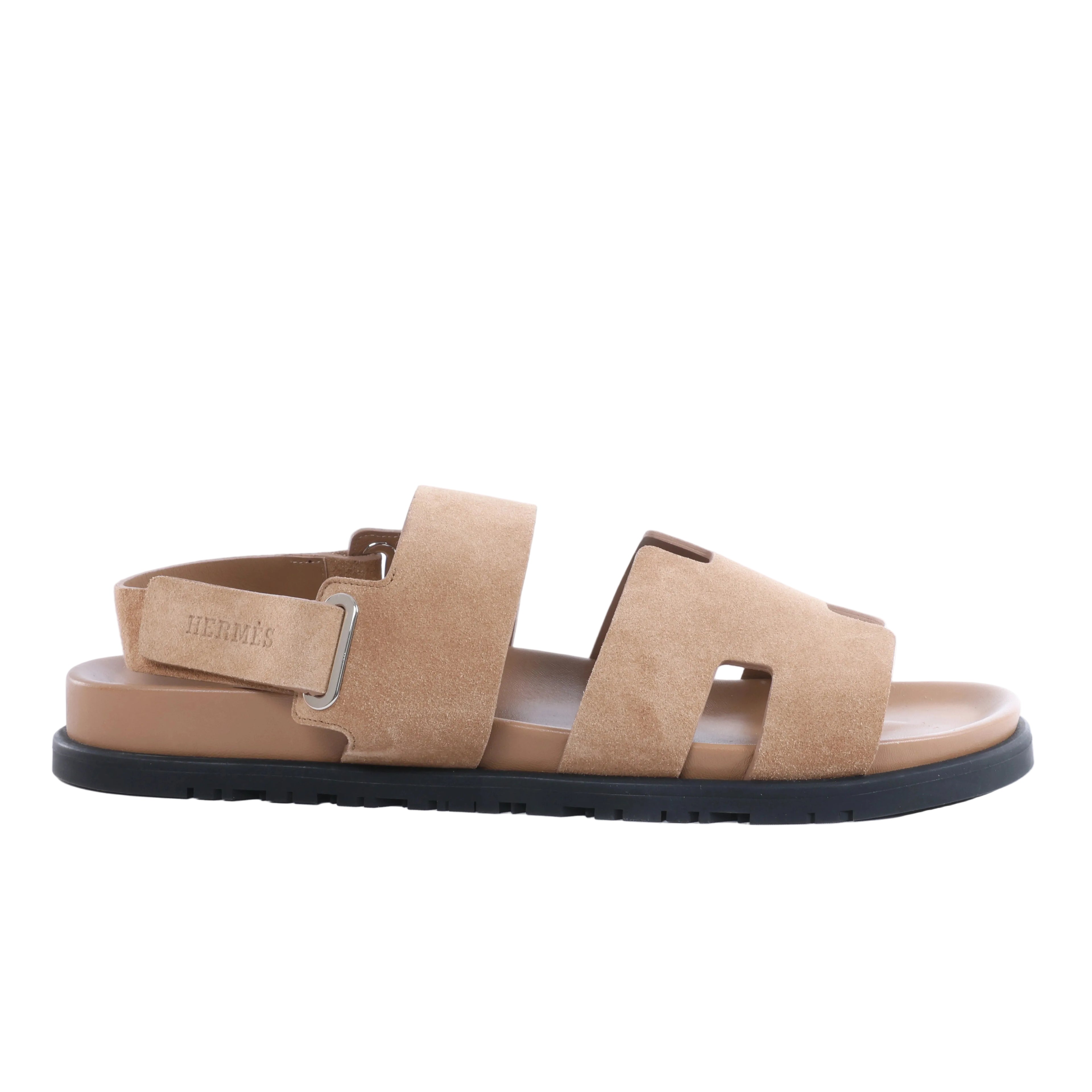 Hermès Genius brown suede sandal with H-cut front straps, back strap, silver-tone hardware and contrasting black sole.