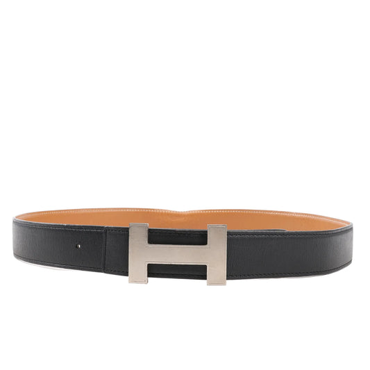 Hermès H Belt T:2015 size 90 featuring black leather exterior, tan interior, and a brushed silver-tone H buckle—reversible and adjustable luxury belt.