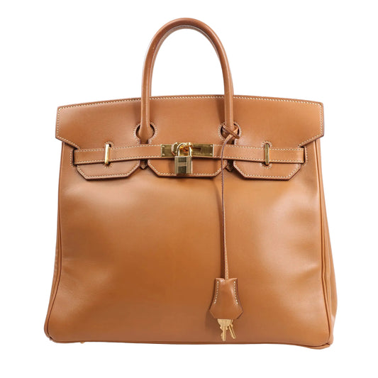 Front view of the Hermès Haut à Courroies 32 handbag (○Y:1995) in smooth brown Vache leather, featuring structured top handles, flap closure with gold-tone hardware, lock and keys in clochette, and classic stitching details.