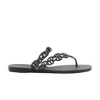 Side view of a black Hermès Island rubber sandal with glossy Chaîne d’Ancre chain-link straps, a toe post and a flat black sole.
