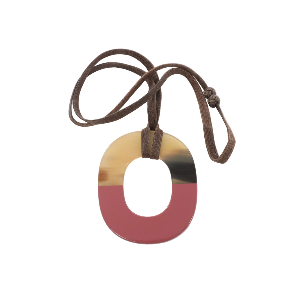 Hermès Isthme oval pendant necklace in brown and pink tones with a long knotted brown cord.
