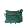 Hermès Jypsière 28 green pebbled leather crossbody bag with palladium-tone clasp, wide strap, and top rings on white background.