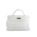 Hermès Kelly 40 handbag in white grained leather with a single top handle, front flap, and silver-tone turn-lock hardware on a white background.