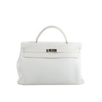 Hermès Kelly 40 handbag in white grained leather with a single top handle, front flap, and silver-tone turn-lock hardware on a white background.