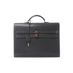 HERMÈS Kelly Depeche 38 briefcase in gray textured leather with white contrast stitching, top handle, silver-tone lock, clochette and keys.