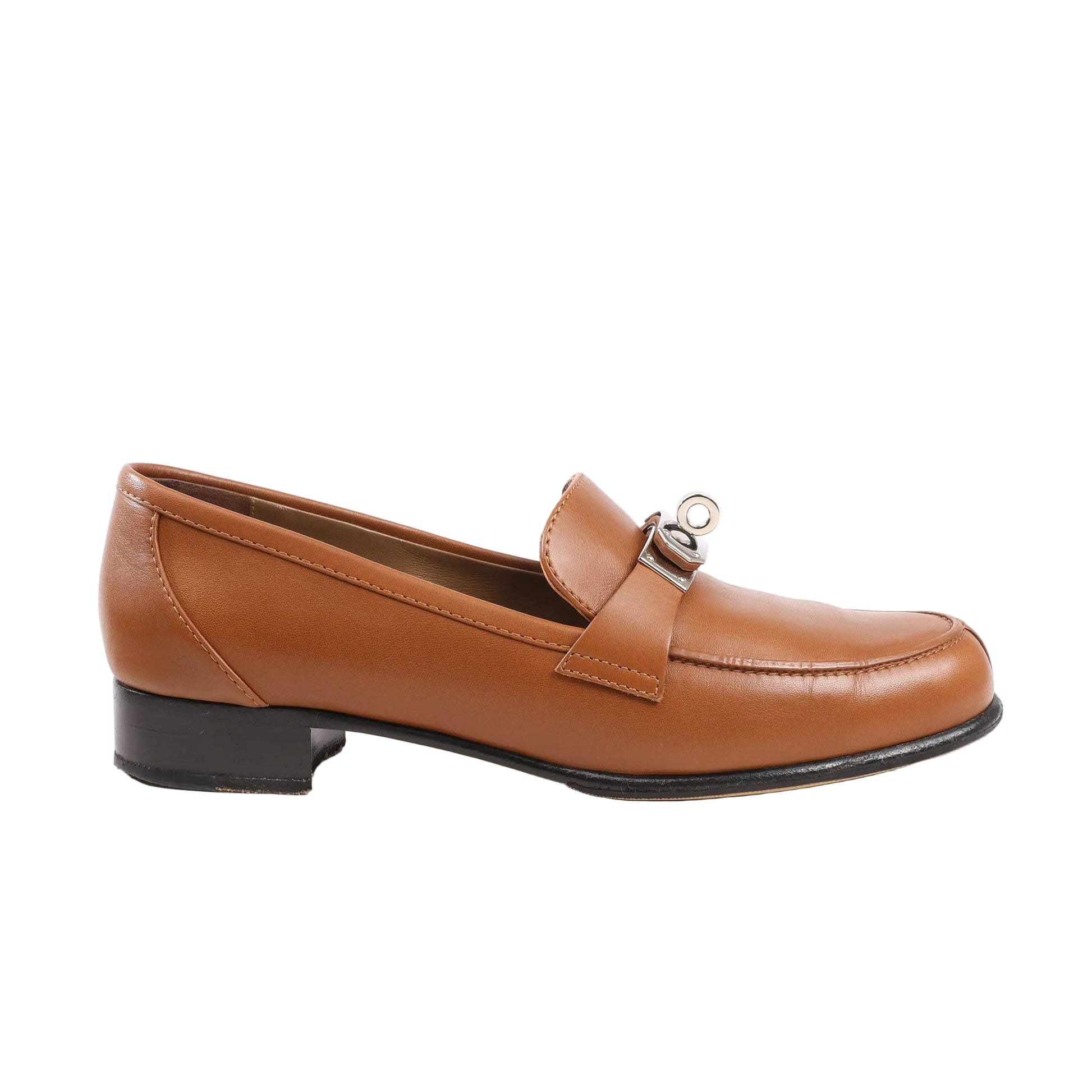 HERMÈS Kelly Loafer in smooth brown leather, size 37 EU, featuring a low heel, rounded toe, and silver-tone Kelly turn-lock detail on the strap, set against a white background.