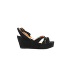 Black suede wedge platform sandals with black leather straps and silver-tone buckle details, photographed in side profile on a white background.