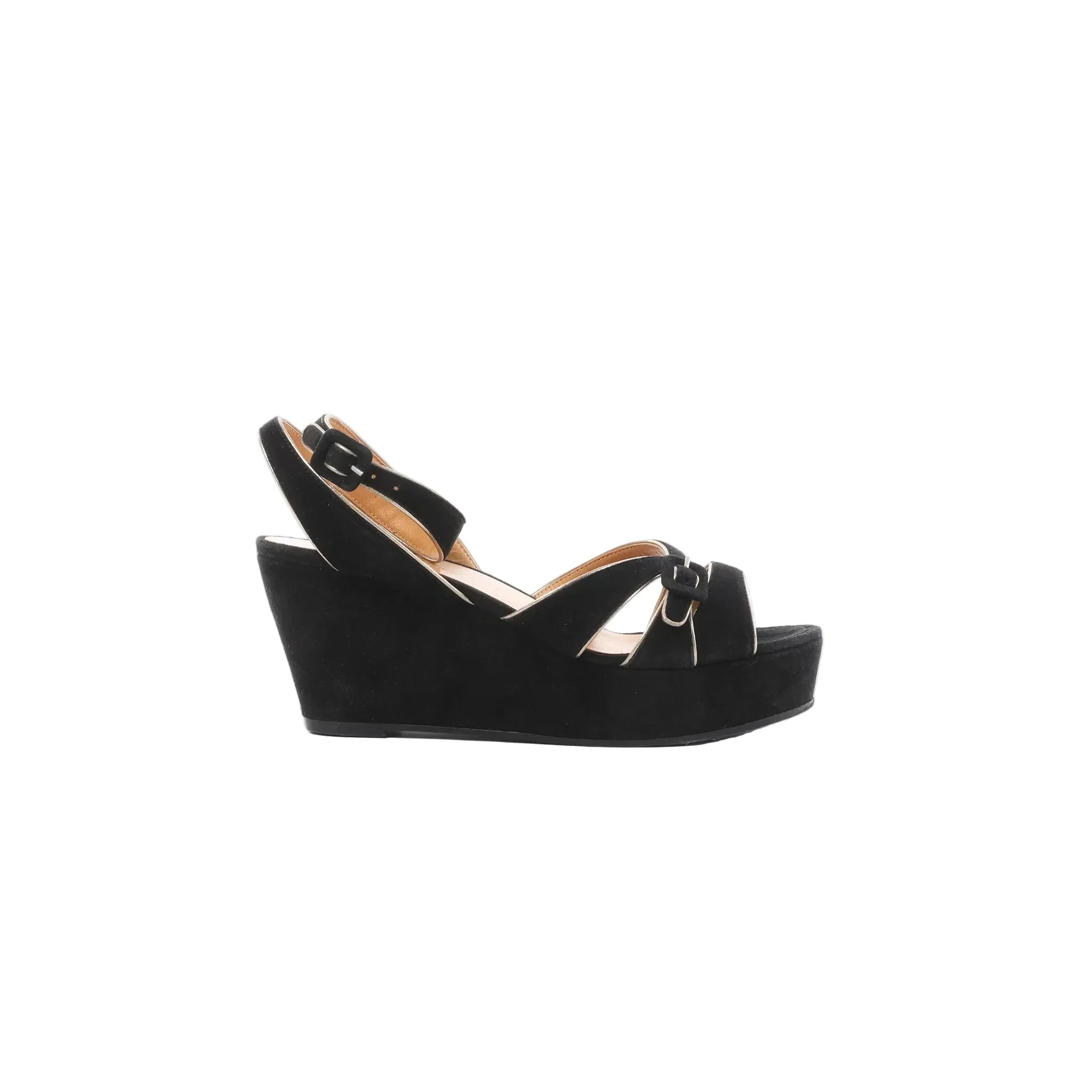 Black suede wedge platform sandals with black leather straps and silver-tone buckle details, photographed in side profile on a white background.
