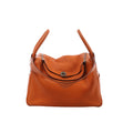 Orange Hermès Lindy 34 Taurillon Clemence leather handbag with dual handles, shoulder strap, flap closure and silver-tone hardware.